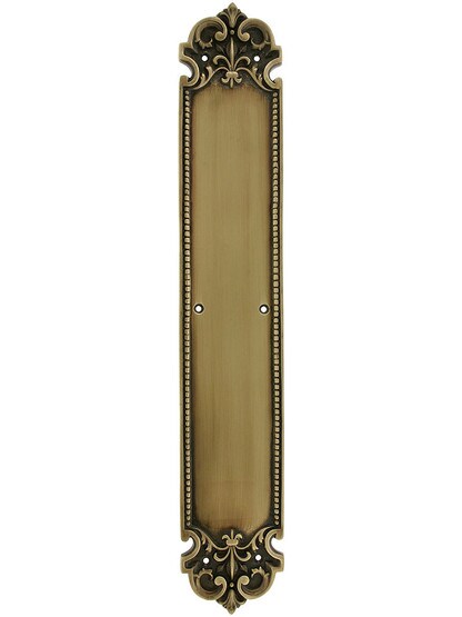 French Baroque Push Plate In Antique Brass.